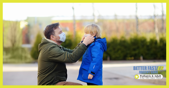 father putting mask on child covid-19 winter